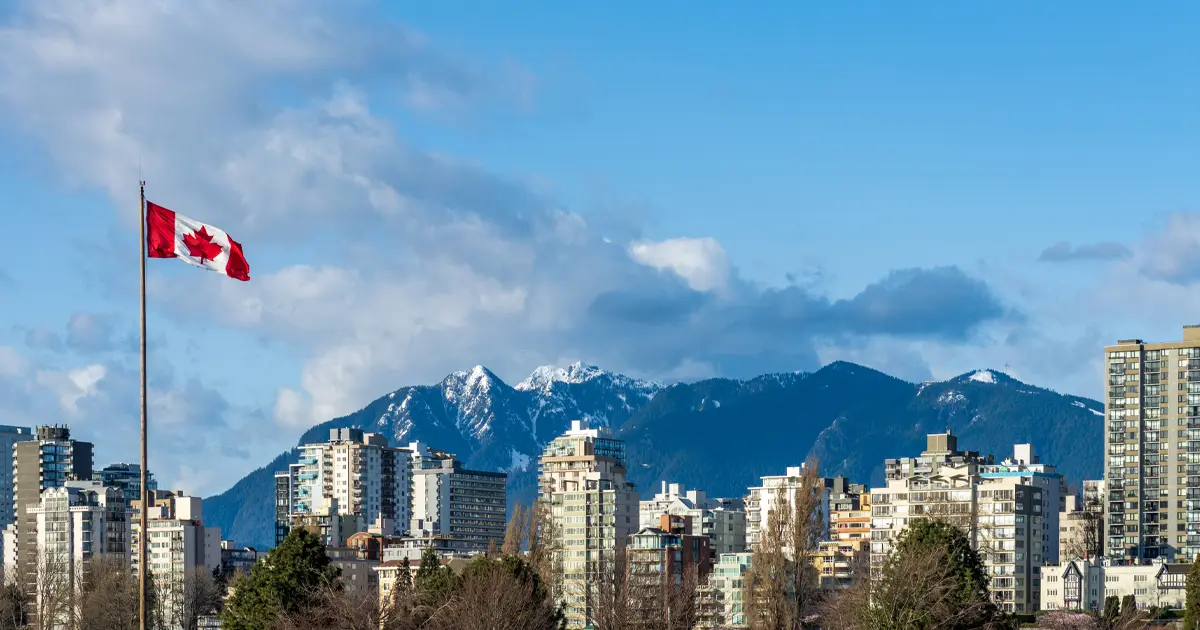 National Flag of Canada with Vancouver City downtown condominium apartment skyline panorama view
